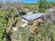 Birds-eye view of home with metal roof, fenced yard, landscaping, and mature trees offering privacy at 7013 Beverly Rd, Lakeland, FL 33813