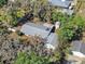 Aerial view of the property showcasing the roof, fenced yard, and proximity to lush foliage at 7013 Beverly Rd, Lakeland, FL 33813