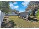 Spacious backyard featuring a shed, white fence, and a well-maintained lawn at 7013 Beverly Rd, Lakeland, FL 33813