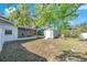 Spacious backyard featuring a storage shed and screened patio, perfect for outdoor living at 7013 Beverly Rd, Lakeland, FL 33813