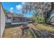 Large backyard with a patio, fire pit, and mature trees offering shade and privacy at 7013 Beverly Rd, Lakeland, FL 33813