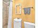 Bathroom with tiled shower, neutral color scheme, vanity and integrated sink at 7013 Beverly Rd, Lakeland, FL 33813
