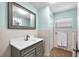 Updated bathroom features a large mirror, modern vanity and sink, and white subway tile at 7013 Beverly Rd, Lakeland, FL 33813