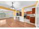 Open dining area with hardwood floors and view to the updated kitchen at 7013 Beverly Rd, Lakeland, FL 33813