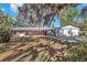Charming single-story brick home featuring a metal roof and separate two car garage at 7013 Beverly Rd, Lakeland, FL 33813