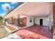 Open front porch with covered carport, painted concrete, and brick columns at 7013 Beverly Rd, Lakeland, FL 33813