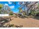 Expansive front yard with mature trees framing this appealing home with metal roof at 7013 Beverly Rd, Lakeland, FL 33813