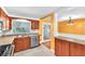 Bright kitchen featuring stainless steel appliances, wood cabinets, and a large window over the sink at 7013 Beverly Rd, Lakeland, FL 33813