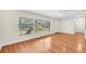 Open living room with hardwood floors and view to the large front windows at 7013 Beverly Rd, Lakeland, FL 33813