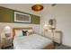 Stylish bedroom features decorative lamps, cozy textiles, and a decorative green accent wall at 8207 Sw 52Nd Lane Rd, Ocala, FL 34481