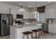 Modern kitchen featuring stainless steel appliances, white cabinetry, marble countertops and eat-in island at 8207 Sw 52Nd Lane Rd, Ocala, FL 34481