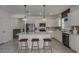 Bright kitchen with stainless steel appliances, eat-in island, white cabinetry, and stylish pendant lighting at 8207 Sw 52Nd Lane Rd, Ocala, FL 34481