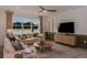 Cozy living room featuring a large window, comfortable seating, stylish decor, and ceiling fan at 8207 Sw 52Nd Lane Rd, Ocala, FL 34481