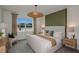 Stylish main bedroom featuring a large window, a modern light fixture, and neutral decor at 8207 Sw 52Nd Lane Rd, Ocala, FL 34481