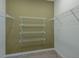 A walk-in closet featuring white wire shelving and neutral carpeting for organized storage at 8207 Sw 52Nd Lane Rd, Ocala, FL 34481