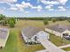 Aerial view of a well-kept home with a large, landscaped front yard and a spacious backyard overlooking a field at 1780 Jackson Oaks Dr, Bartow, FL 33830