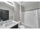 Bathroom featuring a shower and bath, a dark wood cabinet, and a white sink at 1780 Jackson Oaks Dr, Bartow, FL 33830