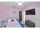 Pink bedroom with ceiling fan, bed with railings, and black door at 1780 Jackson Oaks Dr, Bartow, FL 33830