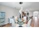 Elegant dining room with glass table and chairs adjacent to the kitchen at 1780 Jackson Oaks Dr, Bartow, FL 33830