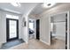 Hallway with neutral walls, tile flooring, an archway, and access to the bathroom and bedrooms at 1780 Jackson Oaks Dr, Bartow, FL 33830
