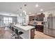 Bright kitchen with stainless steel appliances, central island with bar stools, and open dining area at 1780 Jackson Oaks Dr, Bartow, FL 33830