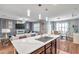 Open floorplan kitchen with island sink overlooking living room and dining areas at 1780 Jackson Oaks Dr, Bartow, FL 33830