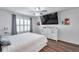 Beautiful main bedroom features great natural light, a flat-screen TV, and nice window sheers at 1780 Jackson Oaks Dr, Bartow, FL 33830