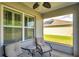 Cozy screened porch with comfortable seating and a view of a nearby home at 1780 Jackson Oaks Dr, Bartow, FL 33830