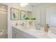 Bathroom featuring double sinks, neutral decor, and a large mirror reflecting a bright, clean space at 2418 Slippery Rock St, Auburndale, FL 33823