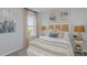 Bright bedroom with a neutral color palette, soft textures, and natural light through the window at 2418 Slippery Rock St, Auburndale, FL 33823