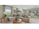 Open-concept living room with tile flooring, comfortable seating, and lots of natural light at 2418 Slippery Rock St, Auburndale, FL 33823