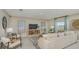 Open-concept living room with tile floors and comfortable sofa and chairs at 2418 Slippery Rock St, Auburndale, FL 33823