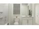 Clean bathroom with white vanity, shower-tub combo, and minimalist decor at 5031 Barnet Dr, Davenport, FL 33837