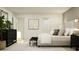 Bedroom with black dresser and bench, king bed, side tables with lamps, and neutral decor at 5031 Barnet Dr, Davenport, FL 33837