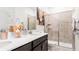 Well-appointed bathroom featuring double sinks, white countertops, and a tiled shower with built-in shelving at 5107 Bridgehaven Rd, Davenport, FL 33837