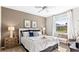 Serene bedroom with ample natural light, featuring a plush bed, stylish nightstands, and a cozy window seat at 5107 Bridgehaven Rd, Davenport, FL 33837