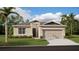 Charming single-story home with a well-manicured lawn, complemented by a two-car garage and neutral color palette at 5107 Bridgehaven Rd, Davenport, FL 33837