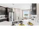 Bright kitchen showcases stainless steel appliances, a white countertop, and a sunlit breakfast nook with picturesque views at 5107 Bridgehaven Rd, Davenport, FL 33837