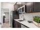 Modern kitchen features stainless steel appliances, subway tile backsplash, and sleek dark cabinetry at 5107 Bridgehaven Rd, Davenport, FL 33837