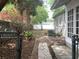 Landscaped backyard with a brick paver walkway, lush greenery, and a privacy fence at 645 W Winter Park St, Orlando, FL 32804