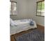 Bedroom featuring hardwood floors and a bed with a white and blue quilt at 645 W Winter Park St, Orlando, FL 32804