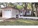 Lovely home with a garage, textured walls, and beautifully landscaped front yard at 645 W Winter Park St, Orlando, FL 32804