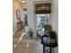 Inviting hallway featuring tile floors, a wicker chair, and decorative tables at 645 W Winter Park St, Orlando, FL 32804