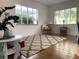 Bright living room with hardwood floors, a decorative rug, and large windows at 645 W Winter Park St, Orlando, FL 32804