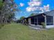 View of home's private lanai, part of a well-maintained, green backyard at 23 Buck Cir, Haines City, FL 33844