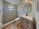 Updated bathroom featuring a walk-in shower, modern vanity, and neutral tile flooring at 23 Buck Cir, Haines City, FL 33844