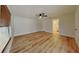 Clean bedroom with wood-look flooring, ceiling fan, and window providing ample natural light at 23 Buck Cir, Haines City, FL 33844