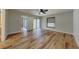 Spacious bedroom featuring wood-look flooring, ceiling fan, and sliding door access to the outside at 23 Buck Cir, Haines City, FL 33844