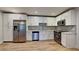 Modern kitchen featuring stainless steel appliances, white cabinets, and a stylish backsplash at 23 Buck Cir, Haines City, FL 33844