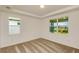 Cozy bedroom with neutral carpet and ample natural light from large windows at 5831 Sw 87Th Ave, Ocala, FL 34481